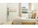 Bedroom featuring a window with blinds and a neutral color palette for a serene atmosphere at 4566 Ochos Rios Pl, Kissimmee, FL 34758
