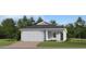 Charming single-story home featuring a symmetrical design, attached garage, and well-maintained front lawn at 4566 Ochos Rios Pl, Kissimmee, FL 34758
