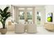 Serene living space with elegant furnishings, large windows, and a seamless flow to other rooms at 4566 Ochos Rios Pl, Kissimmee, FL 34758
