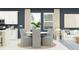 Cozy dining area featuring a round table, comfortable seating, and natural light from the nearby windows at 4578 Ochos Rios Pl, Kissimmee, FL 34758