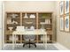 Well-appointed home office with a desk, chair, and built-in bookshelves, ideal for productivity at 4578 Ochos Rios Pl, Kissimmee, FL 34758