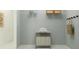 Functional laundry room with shelving and a convenient rolling hamper, making laundry tasks easier at 4578 Ochos Rios Pl, Kissimmee, FL 34758