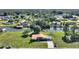 Aerial view of the home and neighborhood, showing canals and mature trees at 6365 Avocado Dr, Indian Lake Estates, FL 33855