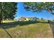 Large, grassy backyard surrounded by mature trees, offering plenty of space for recreation and relaxation at 6365 Avocado Dr, Indian Lake Estates, FL 33855
