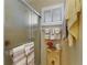 Bright bathroom with a glass shower enclosure, vanity, and decorative wall coverings at 6365 Avocado Dr, Indian Lake Estates, FL 33855
