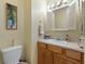 Charming half-bath featuring a decorative mirror, painted accents, and traditional fixtures at 6365 Avocado Dr, Indian Lake Estates, FL 33855