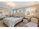 Comfortable bedroom featuring a decorative window, a plush bed, and a mirrored closet at 6365 Avocado Dr, Indian Lake Estates, FL 33855