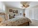 Spacious bedroom featuring a ceiling fan, comfortable bed, and ample closet space at 6365 Avocado Dr, Indian Lake Estates, FL 33855
