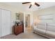 Cozy bedroom features neutral carpet, ceiling fan, a double closet and natural light at 6365 Avocado Dr, Indian Lake Estates, FL 33855