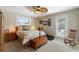 Inviting bedroom featuring a ceiling fan, a comfortable bed, and access to the outdoors at 6365 Avocado Dr, Indian Lake Estates, FL 33855