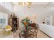 Dining area with decorative table and chairs, showcasing interior design elements and natural light at 6365 Avocado Dr, Indian Lake Estates, FL 33855