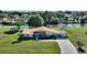 An inviting one-story home with a spacious front yard, attached garage, and scenic waterfront view at 6365 Avocado Dr, Indian Lake Estates, FL 33855