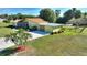 Aerial view of the home showing the attached garage and canal access at 6365 Avocado Dr, Indian Lake Estates, FL 33855