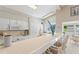 Open kitchen with tile countertops, bar seating, and modern appliances, perfect for entertaining at 6365 Avocado Dr, Indian Lake Estates, FL 33855