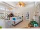 Bright living room featuring high ceilings, ceiling fans, and neutral decor creating an airy atmosphere at 6365 Avocado Dr, Indian Lake Estates, FL 33855