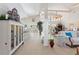 Bright and airy living room with tile flooring, high ceilings, and abundant natural light at 6365 Avocado Dr, Indian Lake Estates, FL 33855