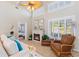 A stylish living room with a cozy fireplace, comfortable seating, and large windows for natural light at 6365 Avocado Dr, Indian Lake Estates, FL 33855