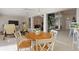 Open-concept living space with dining area, comfortable seating, and seamless flow to other areas at 6365 Avocado Dr, Indian Lake Estates, FL 33855