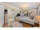 Serene bedroom featuring a cozy bed, chandelier lighting, ensuite bath and ample closet space at 6365 Avocado Dr, Indian Lake Estates, FL 33855