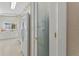 View of a pantry and refrigerator with a tiled floor and access to a bright kitchen area at 6365 Avocado Dr, Indian Lake Estates, FL 33855