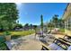 Enjoy outdoor living on this patio with seating, waterfront views, and lush landscaping at 6365 Avocado Dr, Indian Lake Estates, FL 33855