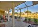 View of tiled, screened-in patio overlooking the well-manicured front yard at 6365 Avocado Dr, Indian Lake Estates, FL 33855