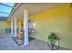 Inviting front porch with colorful decor, stylish seating, and attractive tile flooring at 6365 Avocado Dr, Indian Lake Estates, FL 33855