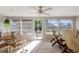Sunroom with tile floors, abundant natural light, and comfortable seating, leading to the outdoors at 6365 Avocado Dr, Indian Lake Estates, FL 33855