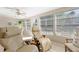 Sunroom with large windows, tile flooring, a ceiling fan, and comfortable seating offering a relaxing space at 6365 Avocado Dr, Indian Lake Estates, FL 33855