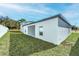 New construction backyard features a landscaped green yard and modern exterior at 13279 Tula Loop, Astatula, FL 34705