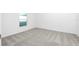 Clean, carpeted bedroom with neutral colors, a window, and ample natural light at 13279 Tula Loop, Astatula, FL 34705