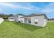 Exterior rear of the house showing green grass and a patio at 13283 Tula Loop, Astatula, FL 34705