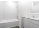 Bright bathroom featuring modern fixtures, tub with white tiled walls and sink with vanity at 13283 Tula Loop, Astatula, FL 34705