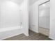 Modern bathroom showcasing white tiled shower over tub and tile flooring at 13283 Tula Loop, Astatula, FL 34705