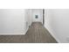 Long hallway with modern flooring leading to a stylish front door at 13283 Tula Loop, Astatula, FL 34705