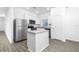 Modern kitchen with stainless steel appliances and a granite countertop island at 13283 Tula Loop, Astatula, FL 34705