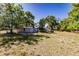 Large backyard with mature trees, offering ample space and privacy for outdoor activities at 4290 Trainer Rd, Bartow, FL 33830