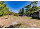 View of expansive backyard with scattered foliage and a storage shed at 4290 Trainer Rd, Bartow, FL 33830