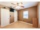 This bedroom boasts wood-look floors, a ceiling fan, and access to storage at 4290 Trainer Rd, Bartow, FL 33830