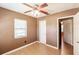 Cozy bedroom with wood-look floors, ceiling fan and a window to let in natural light at 4290 Trainer Rd, Bartow, FL 33830