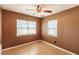 Bedroom with wood-look floors, ceiling fan, and dual windows providing natural light at 4290 Trainer Rd, Bartow, FL 33830