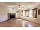 Spacious living room featuring a brick fireplace and wood-look floors, creating a cozy atmosphere at 4290 Trainer Rd, Bartow, FL 33830