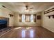 Spacious living room featuring a brick fireplace and wood-look floors, creating a cozy atmosphere at 4290 Trainer Rd, Bartow, FL 33830