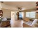 Inviting living room featuring a ceiling fan, wood-look floors, and lots of natural light at 4290 Trainer Rd, Bartow, FL 33830