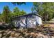 A backyard shed with a garage door and some storage space, on a sunny day at 4290 Trainer Rd, Bartow, FL 33830