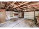 Interior view of a shed with bare stud walls, garage door, and an open ceiling with rafters at 4290 Trainer Rd, Bartow, FL 33830