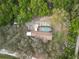 Wide aerial view of the wooded surrounding area with home, large pool, and long driveway at 4586 Cr 696, Webster, FL 33597