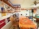 A bar area with a custom wooden bar, seating, and decorated walls at 4586 Cr 696, Webster, FL 33597
