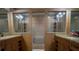 Modern bathroom with dual sinks, granite countertops, and a glass walk-in shower at 4586 Cr 696, Webster, FL 33597