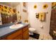 Bright bathroom features decorative sunflower accents and wooden cabinets at 4586 Cr 696, Webster, FL 33597